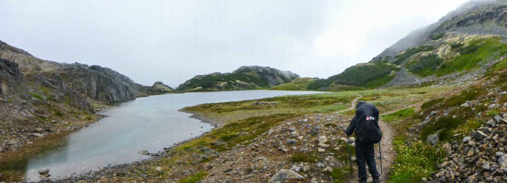 A hiker overlooks a river on the Chilkoot Trail