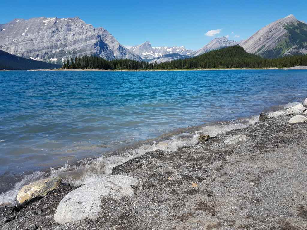 A lake with mountains in the background in Kananaskis Country