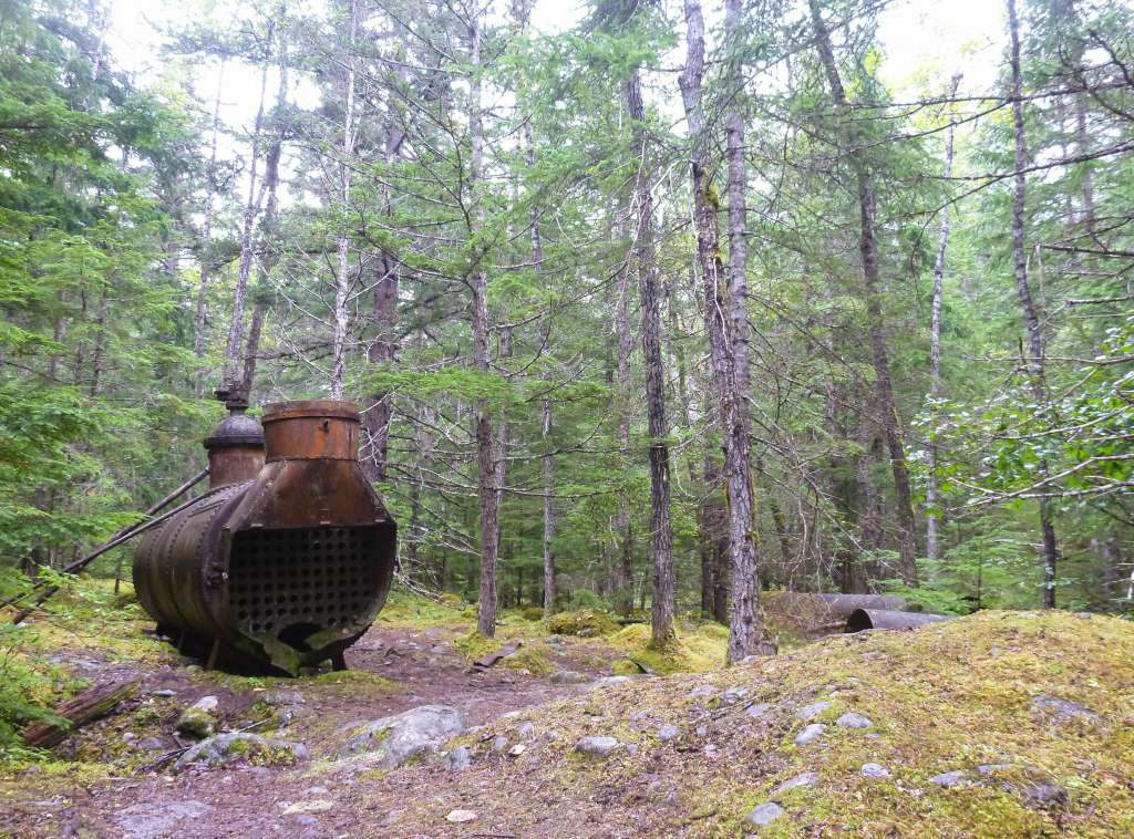 An old rusty boiler sits along the Chilkoot Trail