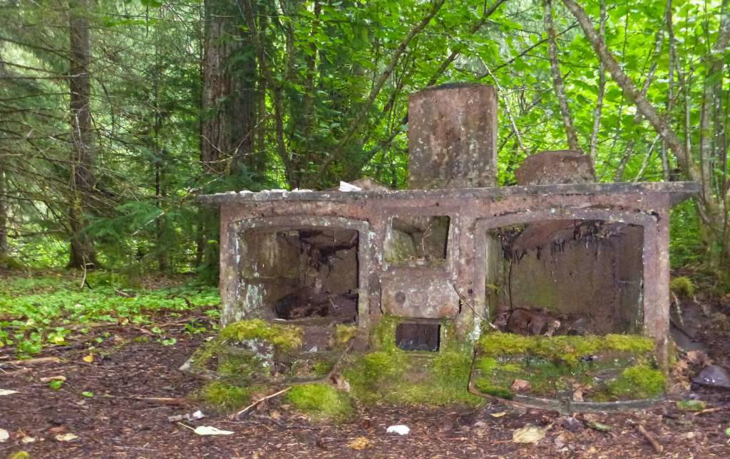 An old rusty stove sits along the Chilkoot Trail
