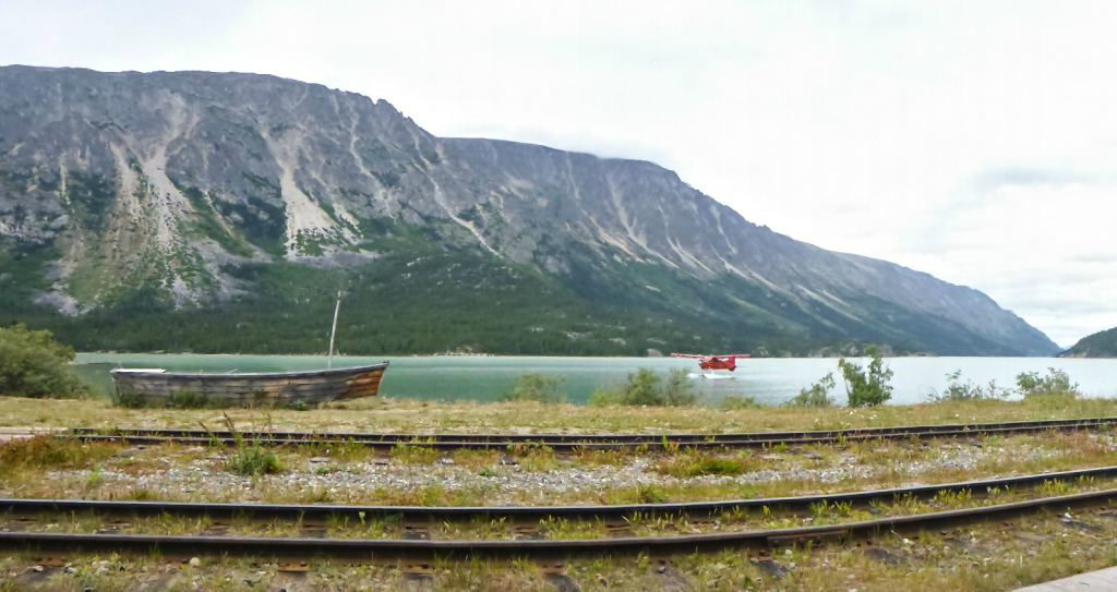 A float plane lands on a lake at the end of the Chilkoot Trail