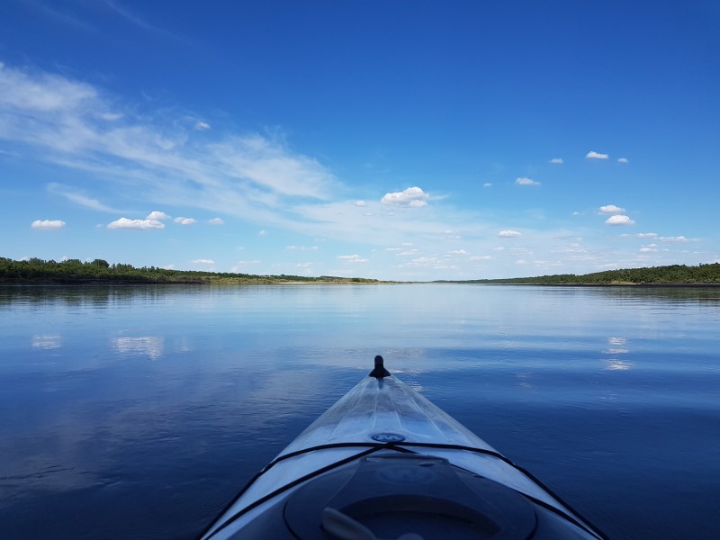 View of the river from the bow of a kayak