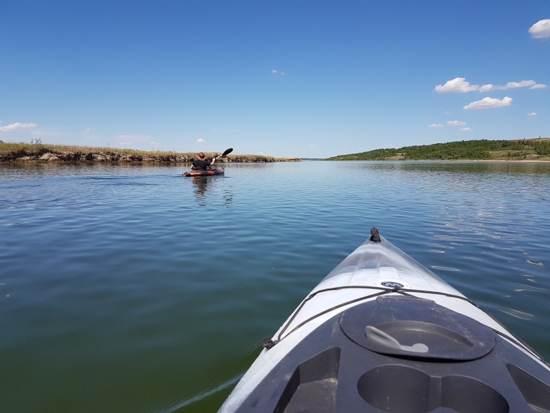 A kayaker paddles down a river