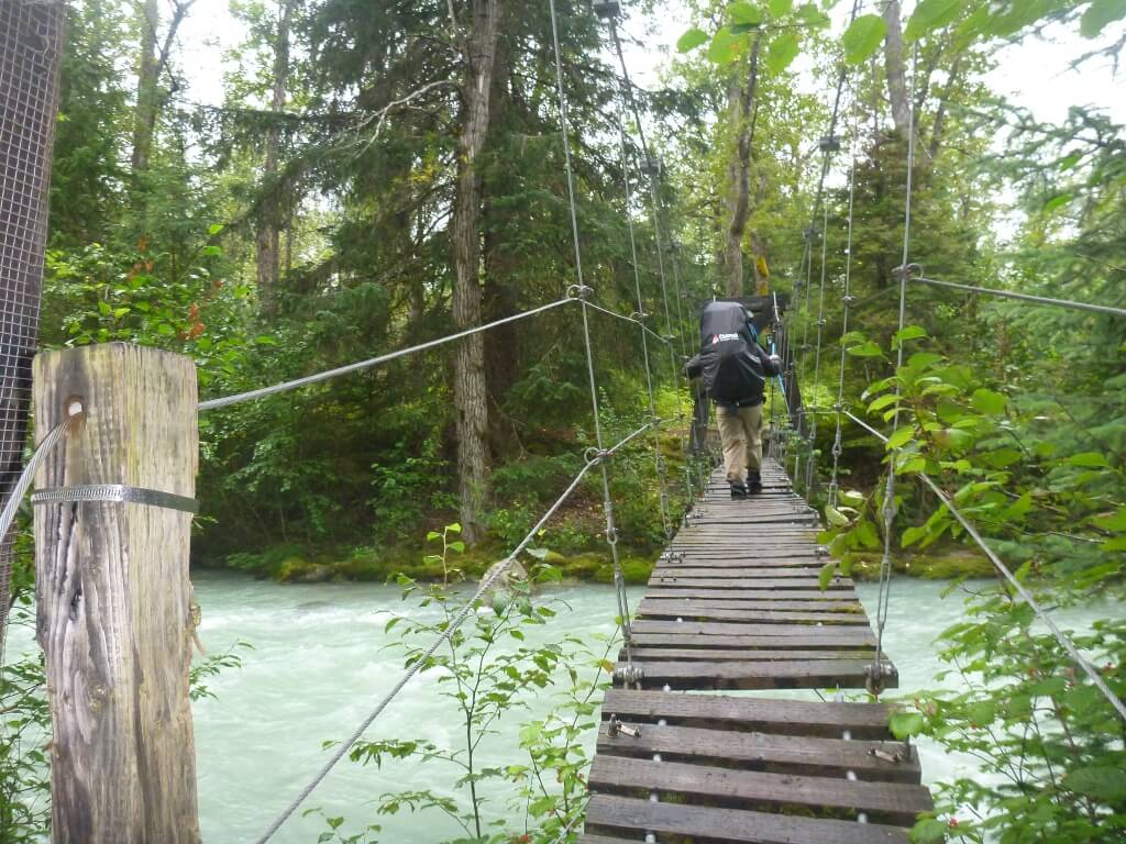A backpacker crossed a suspension bridge across a river