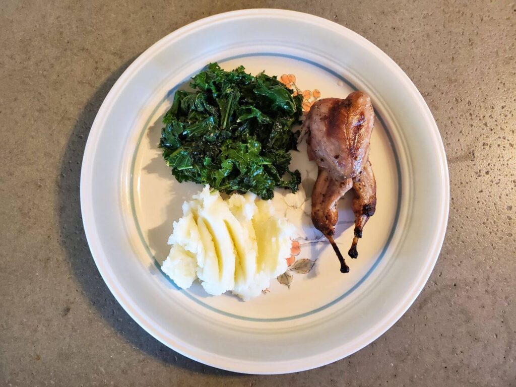 Grilled quail with mashed potatoes and sauted kale.