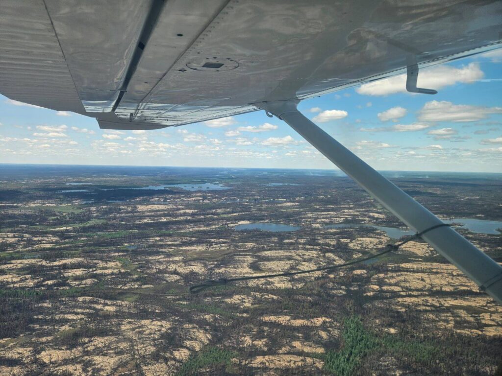 Looking out over charred land from a floatplane